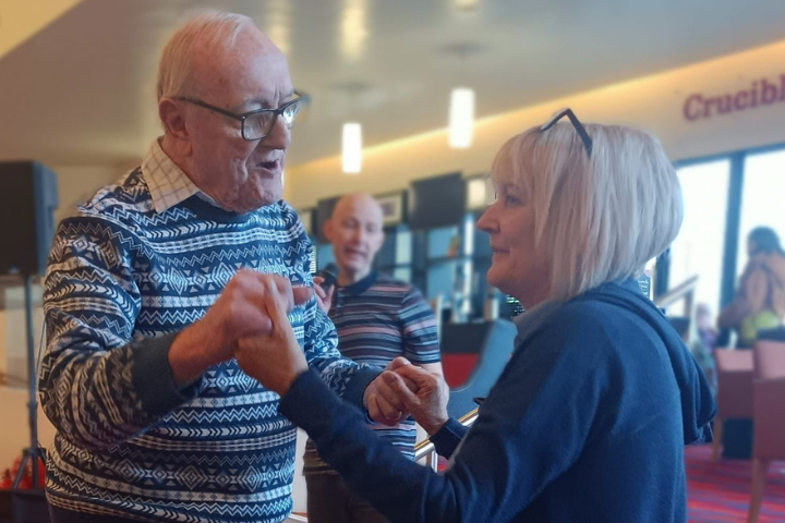 Male service user dancing with female care worker