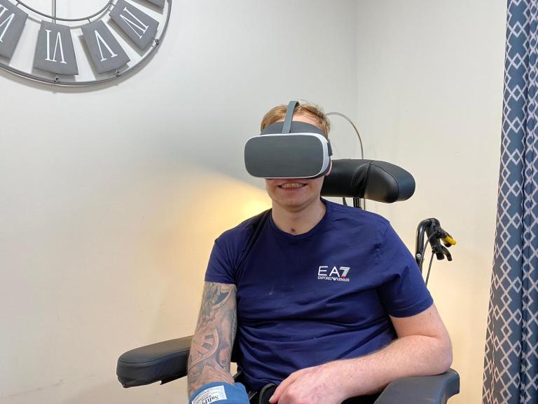 Male care home resident using virtual reality headset