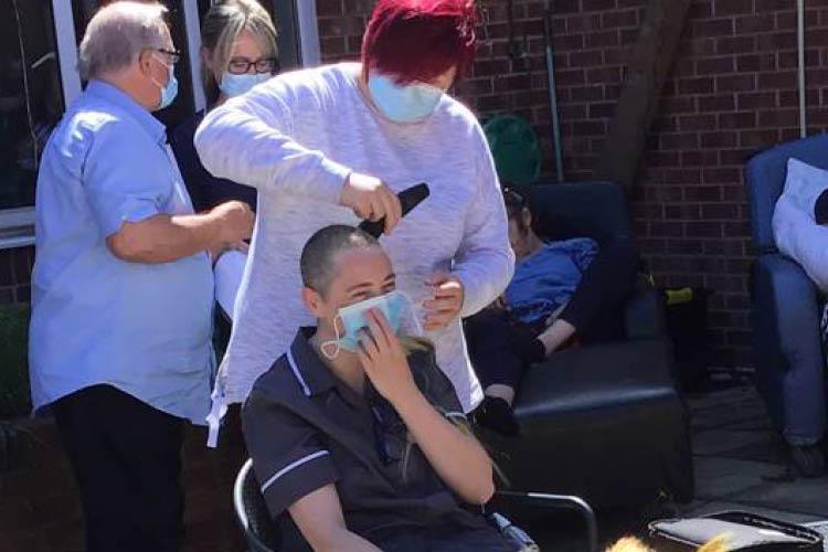 Lady having hair shaved for charity