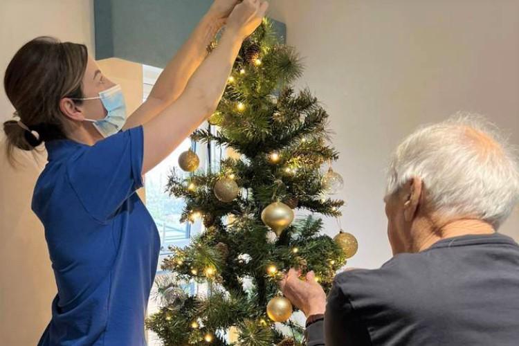 Service user helping to decorate Christmas tree