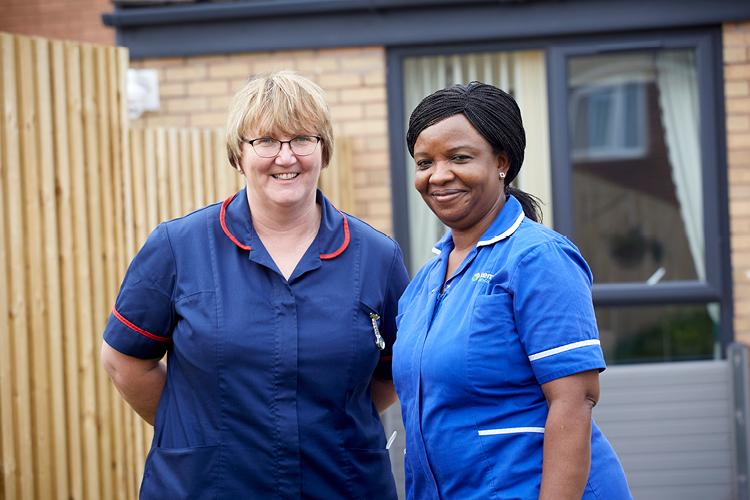 Two Nurses stood outside a care home