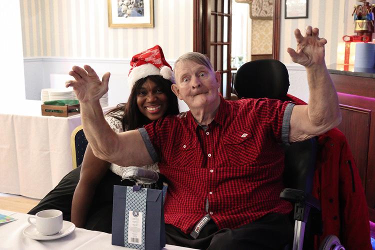 Male service user and woman in christmas hat