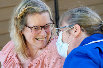Smiling lady looking at Health Care Assistant