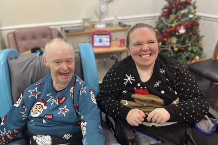 Male service user and Health Care Assistant wearing Christmas jumpers