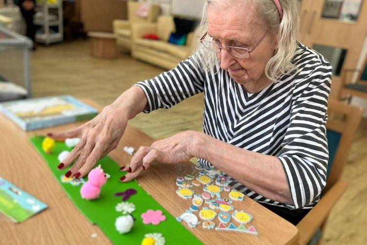Service user doing Easter arts and crafts in care home