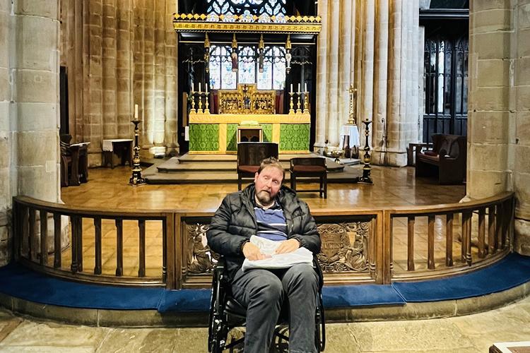 Robert sat in front of the alter in a church