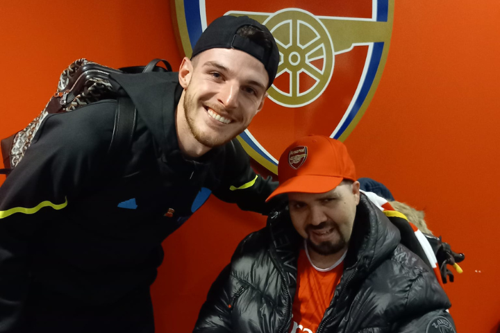 Male service user in wheelchair with football player Declan Rice