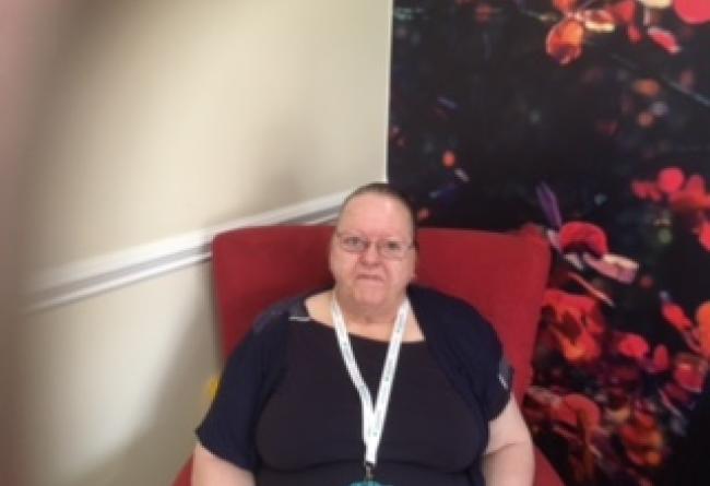 Eastlands resident, Sue sat in a chair